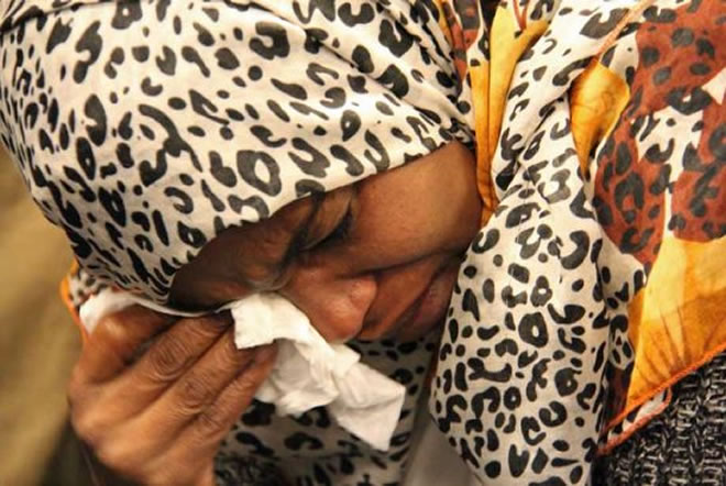 Khadija Ahmed breaks down in tears after speaking to reporters on Monday.