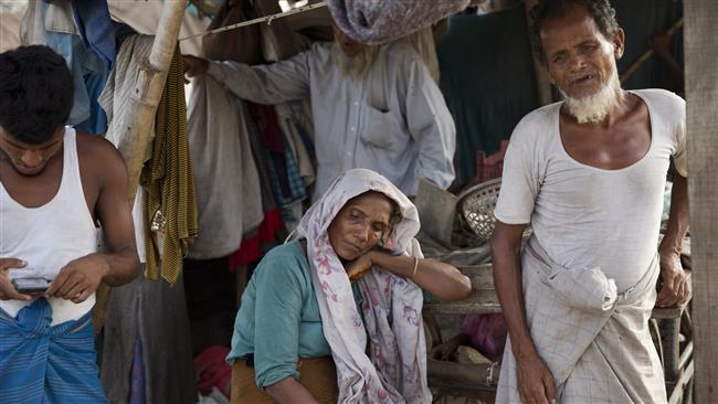 Rohingya refugees stand inside their slum on the outskirts of New Delhi, India, September 3, 2015. ©AP