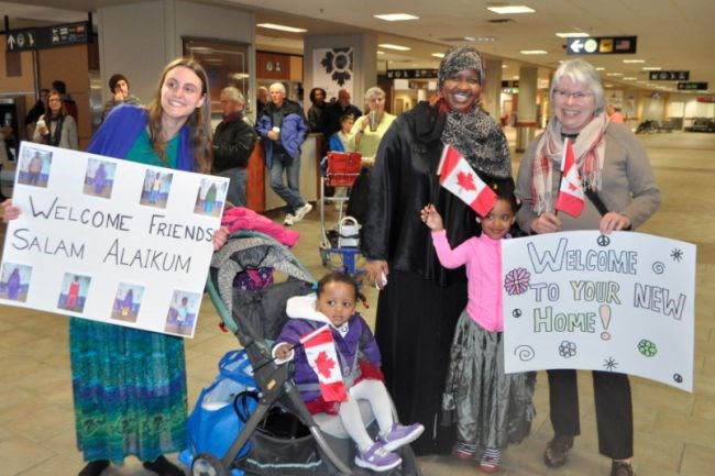Interpreter Lul Omar, centre, her two little girls and members of the Centreville Aldershot Refugee Sponsorship committee await the arrival of the Somali family on April 26.