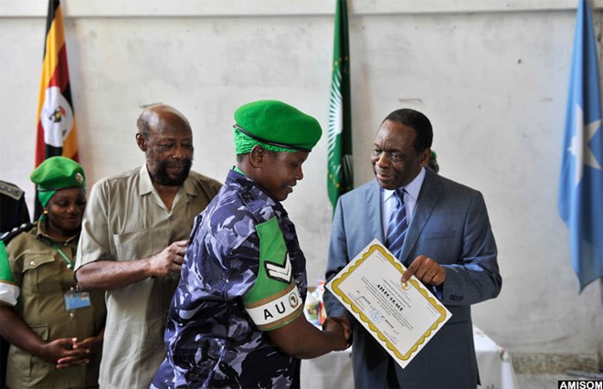Ambassador Madeira hands Atubo Grace a certificate of recognition. (Credit: AMISOM) -