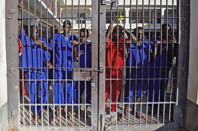 Somali prisoners convicted of piracy, stand behind a gate of the prison in Garowe, Puntland state, in northeastern Somalia, on December 14, 2016. The prison facilitates the rehabilitation of convicted Somali pirates and suspected Al-Shabaab jihadists. (MOHAMED ABDIWAHAB/AFP/Getty Images)