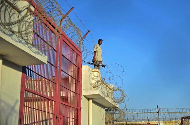 A prison warden stands at a prison in Garowe, Puntland state, in northeastern Somalia. The prison facilitates the rehabilitation of convicted Somali pirates and suspected Al-Shabaab jihadists. (MOHAMED ABDIWAHAB/AFP/Getty Images)