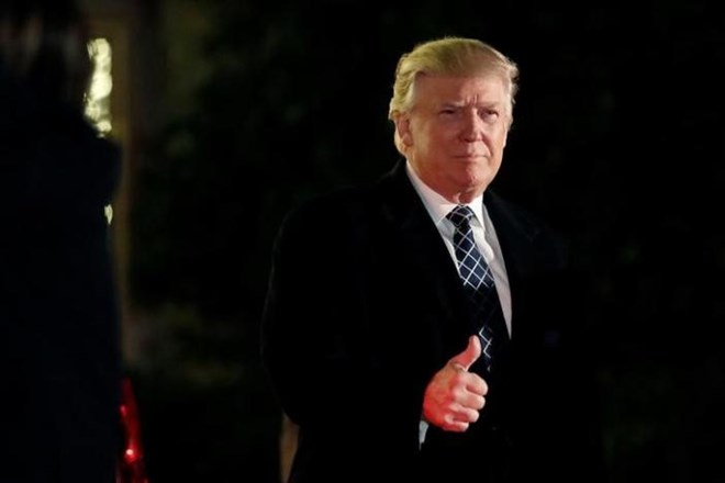 U.S. President-elect Donald Trump gives a thumbs up to the media as he arrives at a costume party at the home of hedge fund billionaire and campaign donor Robert Mercer in Head of the Harbor, New York, U.S., December 3, 2016. REUTERS/mark Kauzlarich
