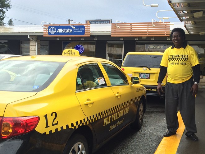 Office manager Dawood Ghedi stands outside PDX Yellow Cab offcies in southeast Portland.