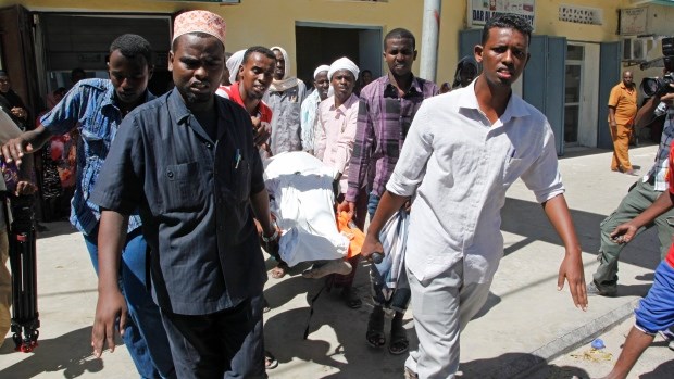 Relatives carry the dead body of a civilian who was killed by a mortar attack in the capital Mogadishu, Somalia, Thursday, Feb. 25, 2016. (AP Photo / Farah Abdi Warsameh)