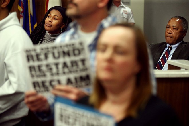 School board members Tracine Asberry left and Don Samuels looked on as in the midst of a motion to select interim superintendent Michael Goar as the board's preferred candidate, protestors shut down the school board meeting. Tuesday January 12, 2016 in Minneapolis, MN.