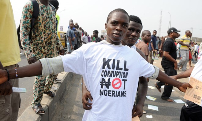 A protester sports an anti-corruption T-shirt in Lagos. The government estimates $6.8bn has been stolen from the treasury over seven years.
Photograph: Pius Utomi Ekpei/AFP/Getty Images