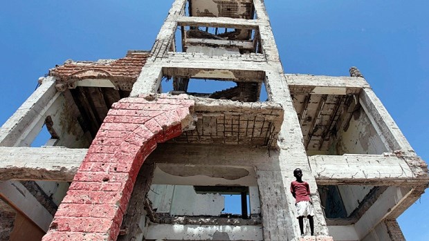 A boy stands on the ruins of the former Somali parliament building in the capital Mogadishu. Somalia has been mired in violence, and lacking effective central government, since the 1991 overthrow of military dictator Siad Barre. (Feisal Omar/Reuters)
