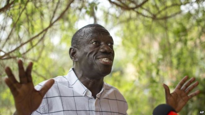 FILE - Opposition leader and presidential candidate Kizza Besigye speaks to the media while under continued house arrest, at his home in Kasangati, outside Kampala, Feb. 21, 2016. A Ugandan judge freed Kizza Besigye on bail Tuesday, rejecting prosecutors' calls for him to be remanded indefinitely until his case is concluded.