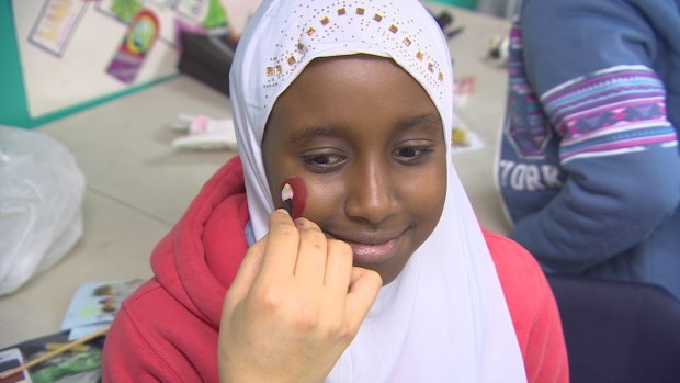 Aisha Hussein, 10, didn't have a costume, so she got her face painted as a balloon for Halloween. (CBC)