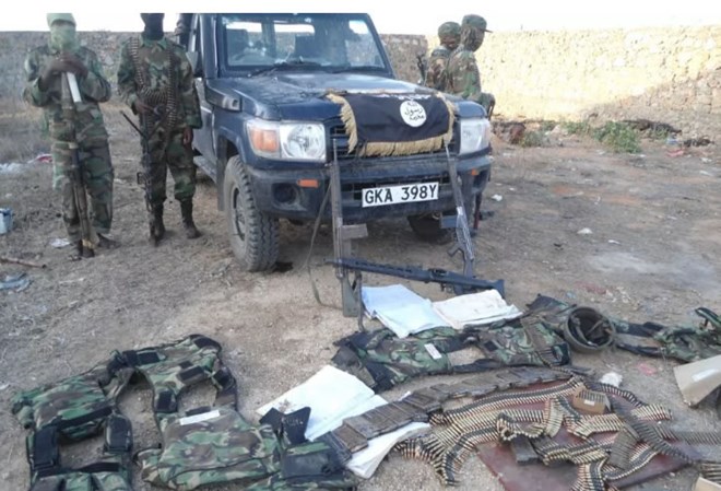 Al-Shabaab militants with Kenyan a police land-cruiser, uniforms and weapons they stole from Hamey police post in Garissa.