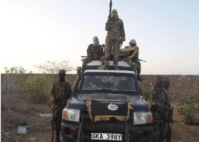 Al-Shabaab militants pose with a police land-cruiser they had stolen from Hamey police post in Garissa.