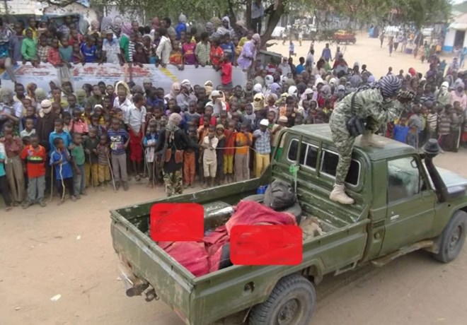 Al-Shabaab militants display bodes they claim are of Kenyan police to residents of Jilib in Southern Somalia.