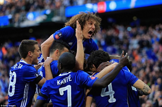 David Luiz piles on top his jubilant team-mates after Matic secured victory with his spectacular goal in the 80th minute