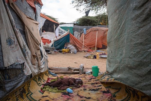 A young boy displaced from his home by the drought sleeps outside a tent in the Mogadishu camp where he and his family live. Photograph: Mackenzie Knowles-Coursin/Unicef