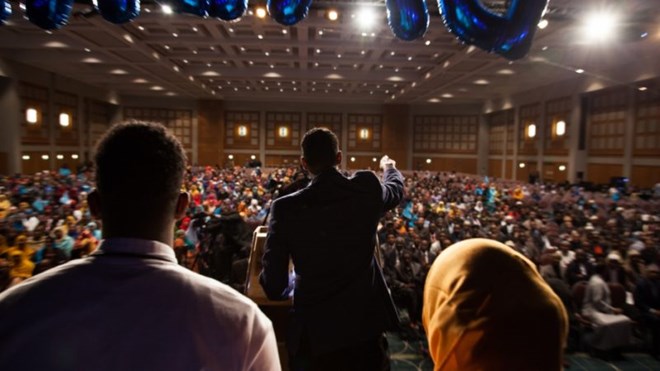 During a rally for the newly elected president of Somalia at the Minneapolis Convention Center, Liban Adam delivers a speech about the ongoing drought in Somalia. He and others in the diaspora and mobilizing online to help. Credit: Arthur Nazaryan/PRI