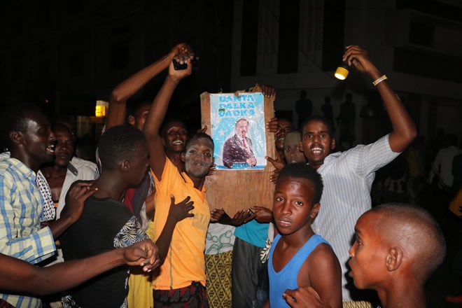 Residents of Mogadishu show off their Farmajo poster after he is named Somalia's next President.HOL/Dalmar Gure