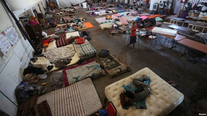 African and Haitian migrants intending to seek asylum in the U.S. rest on mattresses inside a shelter in Mexicali, Mexico, Oct. 5, 2016.