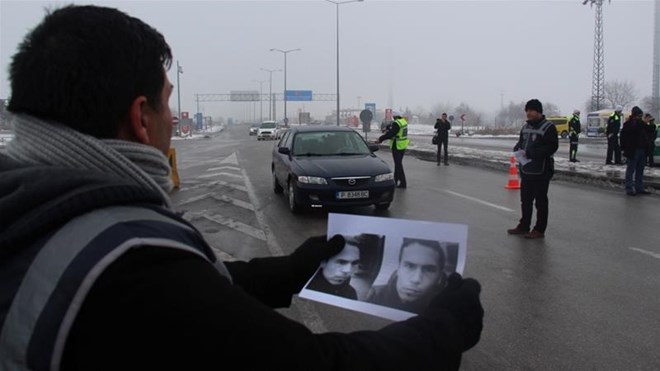 A Turkish police holds pictures of the suspected gunman behind the Reina attack [Reuters]