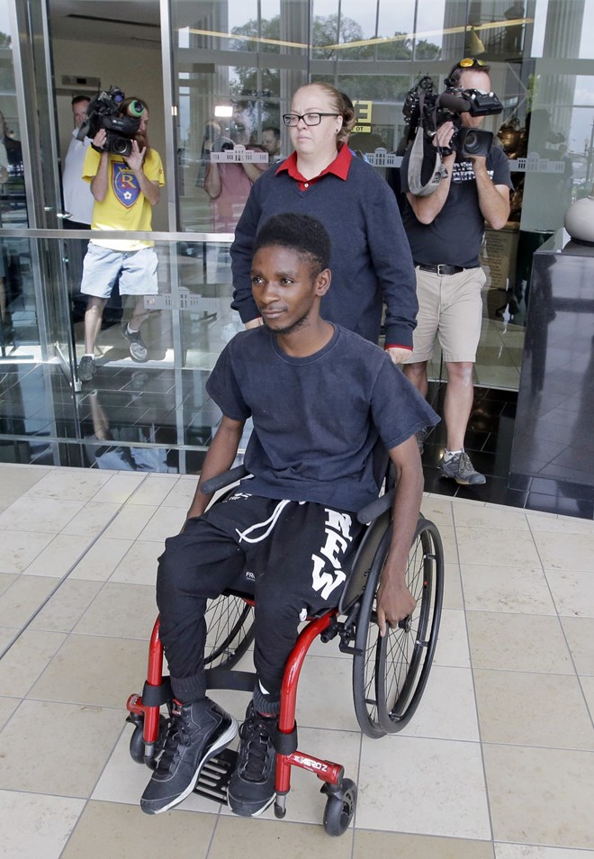 FILE - In this Aug. 10, 2016, file photo, Abdullahi Mohamed, a teenage Somali refugee who was wounded by police during a fight near a homeless shelter, leaves after his first court appearance on robbery and drug charges in Salt Lake City. Prosecutors released videos Monday, Jan. 23, 2017, of the high-profile police shooting that show an officer firing multiple times from short range at Mohamed who was wounded after refusing to drop a metal stick during the fight. (Rick Bowmer, File/Associated Press)