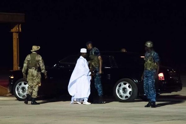 Former president Yaya Jammeh (centre), the Gambia's leader for 22 years, walks towards the plane as he leaves the country on January 21, 2017 in Banjul airport. PHOTO | STRINGER | AFP