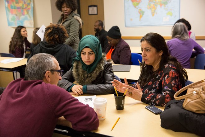 Zainab Abdo, 21, a Syrian refugee, left, and Tara Media, an Iraqi refugee, at a job training session on Thursday with Vito LaMura, an International Institute of New England volunteer in Lowell, Mass.