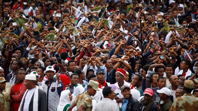 Demonstrators chant slogans while flashing the Oromo protest gesture in October.	(Reuters/Tiksa Negeri)