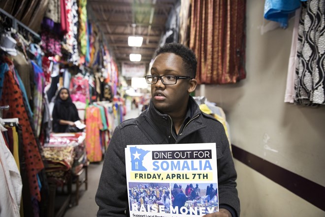 Khalid Mohamed hands out flyers and raises awareness for Dine Out for Somalia at the Village Market mall in Minneapolis.