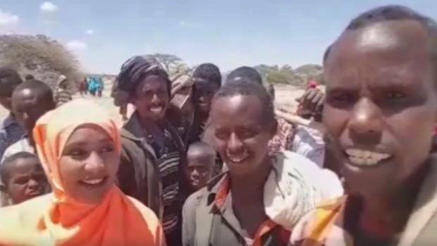 Hodan Nalayeh, founder and host of Integration TV on OMNI TV, talks to a group of Somali nomads about drought conditions in Somalia. (Facebook)