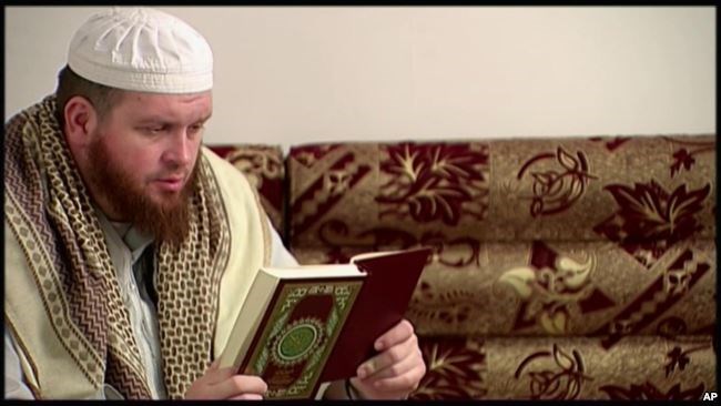 FILE - This image provided by New Zealand 3 News/MediaWorks via APTN shows Mark Taylor, who converted to Islam and is now thought to be in Syria, as he reads the Quran in his native New Zealand.