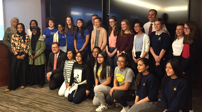 U.S. Bank Chief Innovation Officer Dominic Venturo and Chief Executive Andy Cecere pose with teenage girls the bank sponsored as part of Technovation, a global app-building competition. - Annie Baxter/Marketplace