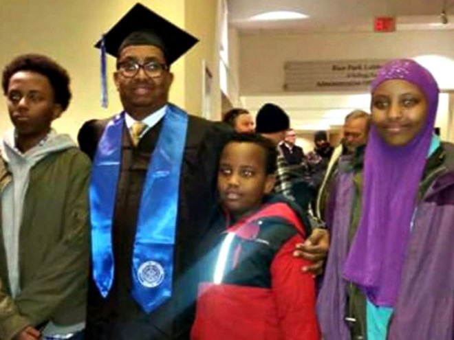 Ahmed Abdikarin Eyow, shown here in a graduation gown with his three children Yonis, Yahya and Yusra, was passionate about education.