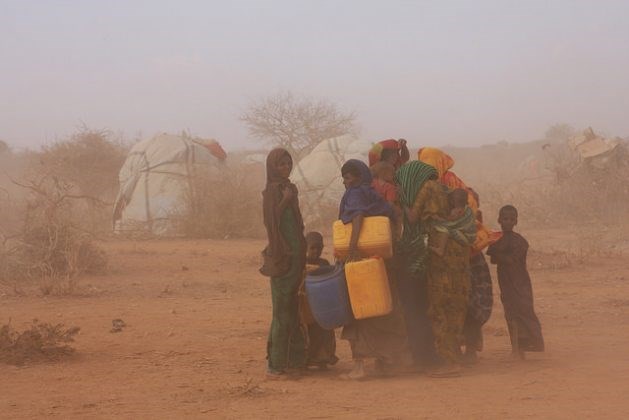 Women and children caught in a dust-laden gust at an IDP settlement 60km south of the town of Gode, reachable only along a dirt track through the desiccated landscape. Credit: James Jeffrey/IPS