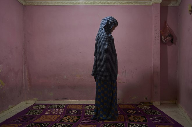 Stahil, a homeless Somali refugee in Jakarta prepares to pray in a boarding house. The 23-year-old, whose family rejected the al-Qaida-affiliated al-Shabaab group’s version of Islamic law, fled Somalia after her father was murdered and she was targeted for shaking hands with a man. There is ‘severe hunger’ here, she says.
Photograph: Aaron Bunch/AAP