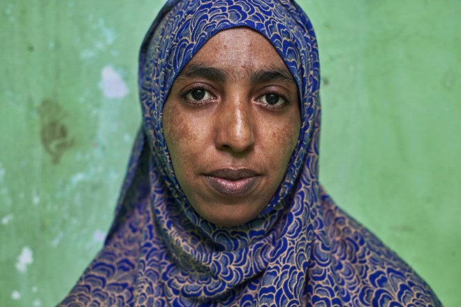 Rahma poses for a photograph in Jakarta. The 25-year-old narrowly escaped death when militants beheaded her father and burned her remaining family members alive in an attack on her family’s business, which had government employees as customers.