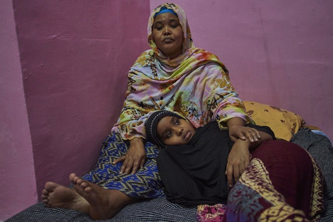Safiya sits with her eight-year-old daughter, Sabrine, in a friend’s room in Jakarta, The pair were smuggled to Indonesia following the beheading of Safiya’s government-employed husband by al-Shabaab in 2015.

.
