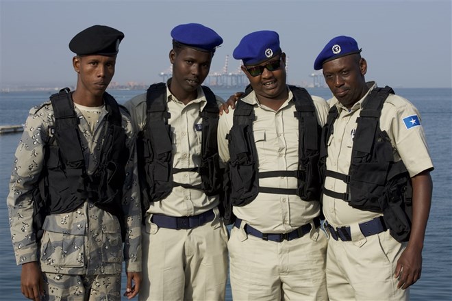Somali maritime police talk together before running through a visit, board, search and seizure drill (VBSS) during exercise Cutlass Express 2018 in the Port of Djibouti Feb. 5, 2018. (U.S. Air National Guard photo by Staff Sgt. Allyson Manners)