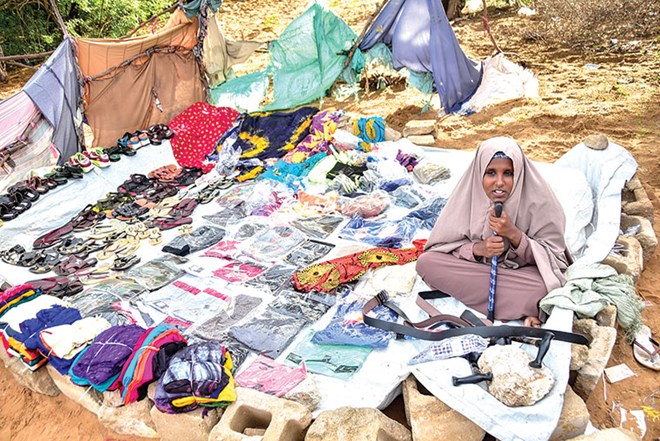 A businesswoman waits for customers in a market