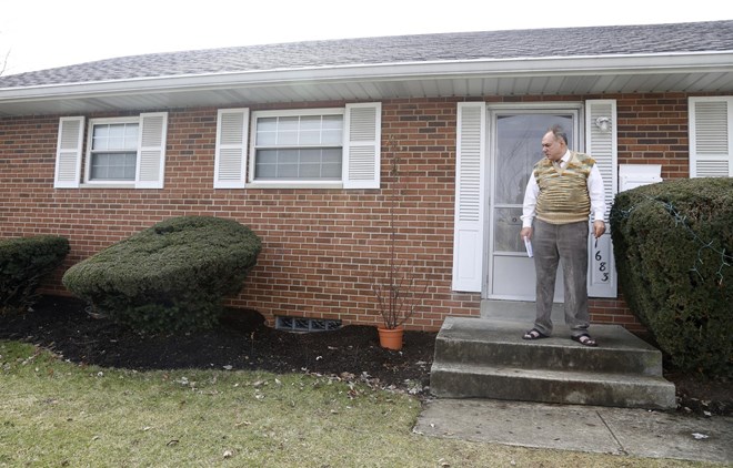 Rifat Moustafa, a Syrian immigrant, takes a smoke break outside his Columbus, Ohio, home on Thursday, Feb. 22, 2018. His 16-year-old son, Hasib Moustafa Rifat, has been separated from his family for more than 18 months as he awaits a U.S. visa. Moustafa, an international lawyer who says he was tortured for protesting human rights violations, was granted asylum and his wife and four other children followed in 2016, before President Trump was elected. They were hoping Hasib could come shortly after, but resettlement officials say the Trump administrationвЂ™s travel ban on refugees from mostly Muslim countries has very likely caused further delays. (AP Photo/Martha Irvine)