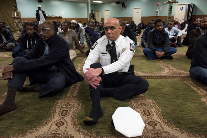 In this Feb. 23, 2018, New American Diversity and Inclusion Officer Khaled Bhagat, with the Columbus Police Department, speaks to members at the Masjid Ibnu Taymiyah Islamic Center after Friday prayer in Columbus, Ohio. Bhagat has been tapped in Ohio’s capital to bridge gaps between police and the city’s growing immigrant population. (AP Photo/Ty Wright)