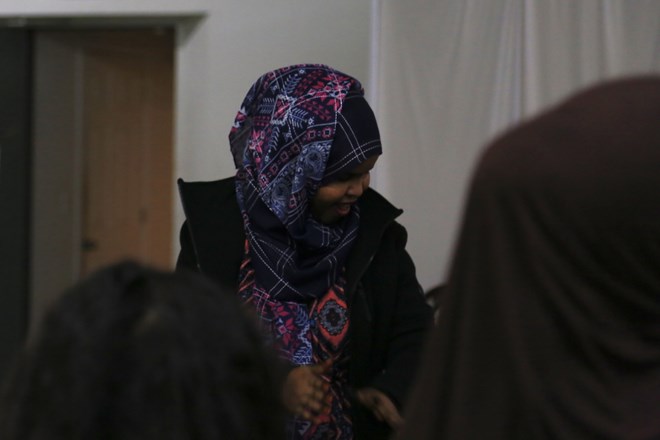 Esther claps along to the music at the Saturday practice. Esther came to the United States at age 15 with her brother, sister and father. Nine years after she arrived, she became a United States citizen. “Now it’s my home,” Esther said. (Photo by Ester Ouli Kim.)