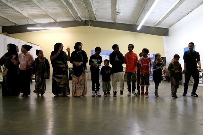 Esther’s five children and other youth line up in formation for part of the dance. All of Esther’s children were born in Washington. Many of the parents of the children pictured have similar stories as Esther. Somali displacement has endured from the 1990s to the present day, according to the United Nations. (Photo by Ester Ouli Kim.)