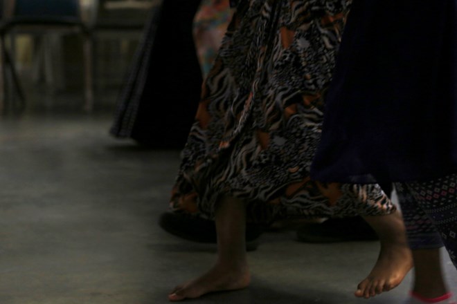 Some of the youth take off their shoes to dance. The group of youth and volunteers also shared personal moments at the practice as a close member of the Somali community had recently passed away. (Photo by Ester Ouli Kim.)