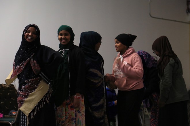 The girls in line wear uniquely patterned skirts as they dance. Esther doesn’t worry too much about her daughters possibly being singled out because of their clothes. She said they live in a great neighborhood with a good community that understands the Muslim faith. (Photo by Ester Ouli Kim.)