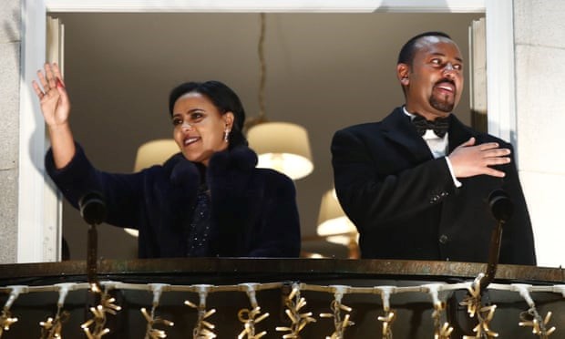 Abiy Ahmed and his wife Zinash Tayachew wave from the balcony of the Grand Hotel in Oslo on 10 December during a torch parade in honour of his Nobel peace prize. Photograph: Terje Pedersen/NTB Scanpix/AFP via Getty Images