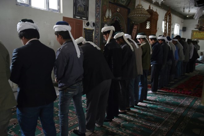 Uighur men pray in a mosque in Hotan, in China's western Xinjiang region, in April 2015