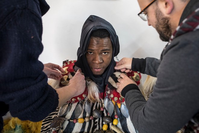 Mohamed being dressed for his role as a page. January 2019.CreditEdu Bayer