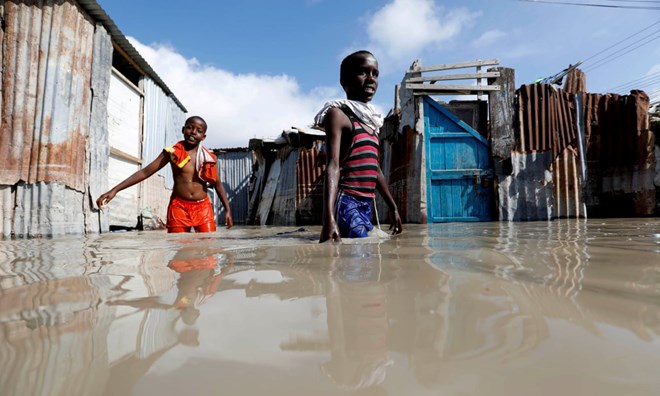 Somali children wade through flood waters after heavy rain in Mogadishu. Photograph: Feisal Omar/Reuters