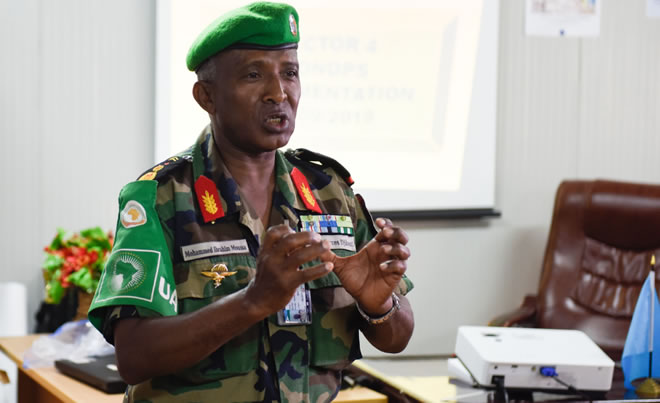 Col. Mohamed Ibrahim Moussa, the AMISOM Sector Four Commander, briefs Maj. Gen. Nakibus Lakara (not pictured), the AMISOM Deputy Force Commander, during a working visit to Beletweyne, Somalia on 15 September 2019. AMISOM Photo / Steven Candia